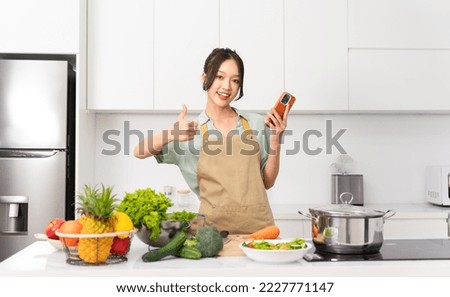 Portrait of a housewife in the kitchen at home Royalty-Free Stock Photo #2227771147