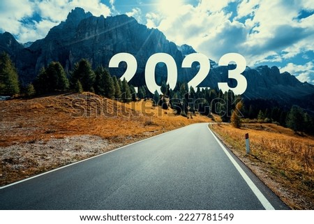 2023 New Year road trip travel and future vision concept . Nature landscape with highway road leading forward to happy new year celebration in the beginning of 2023 for fresh and successful start . Royalty-Free Stock Photo #2227781549