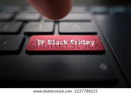 Black friday text and shopping cart on keyboard. Black friday concept. black button on the keyboard of modern ultrabook. caption on the button