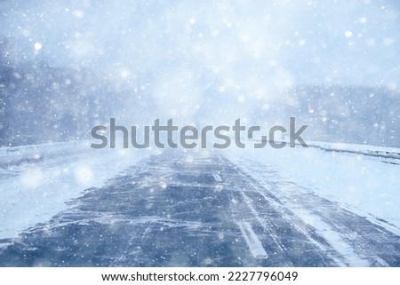 winter highway snowfall background fog poor visibility Royalty-Free Stock Photo #2227796049