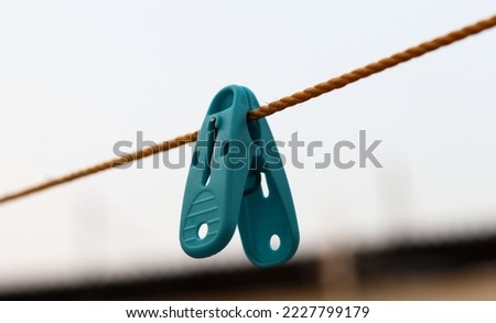 Selective Focus on plastic clothespins on a rope. Round shape Clothespin with rope. 