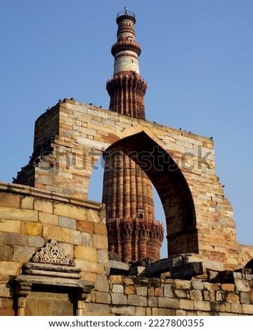 Qutub Minar, One of the most popular places to see in Delhi, is a UNESCO World Heritage Site. The Qutub Minar is a towering 73 meter high tower built by Qutub-ud-Din Aibak.                      Royalty-Free Stock Photo #2227800355