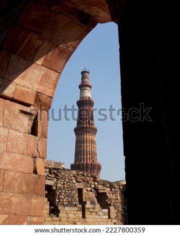Qutub Minar, One of the most popular places to see in Delhi, is a UNESCO World Heritage Site. The Qutub Minar is a towering 73 meter high tower built by Qutub-ud-Din Aibak.                      Royalty-Free Stock Photo #2227800359