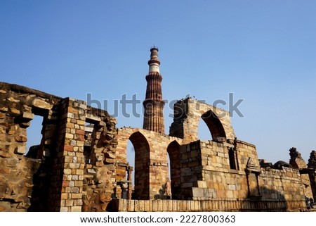 Qutub Minar, One of the most popular places to see in Delhi, is a UNESCO World Heritage Site. The Qutub Minar is a towering 73 meter high tower built by Qutub-ud-Din Aibak.                      Royalty-Free Stock Photo #2227800363