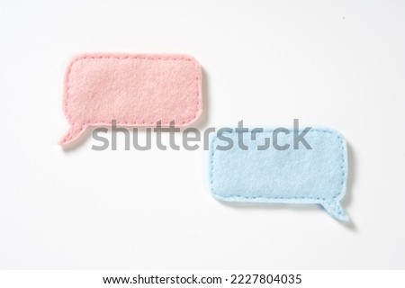 A speech bubble made of felt on a white background