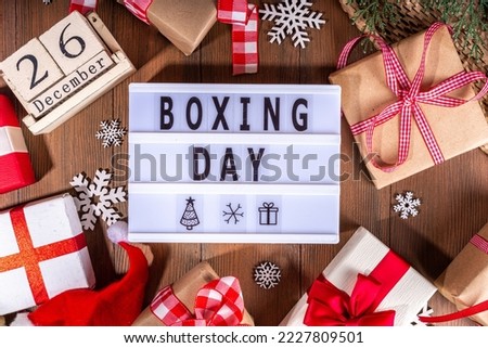 Boxing day sale seasonal promotion background. Various presents gift box with ribbon, with inscription frame Boxing day, block wooden calendar, wrapping holiday paper, Christmas decor, ribbons Royalty-Free Stock Photo #2227809501