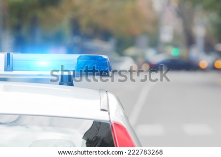 Police car with lights turned on. Royalty-Free Stock Photo #222783268