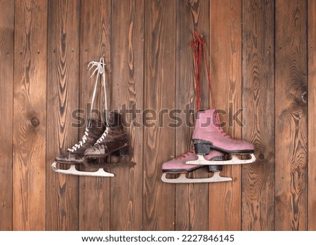 old skates on a wooden wall