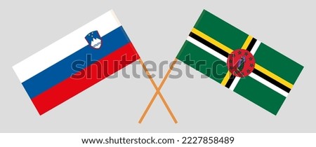 Crossed flags of Slovenia and Dominica. Official colors. Correct proportion. Vector illustration
