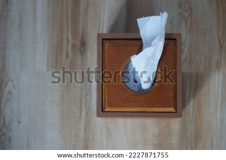 top view white tissue paper in wooden tissue box on brown marble background, object, decor, copy space                                  