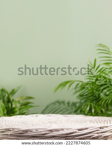 Natural product display for presentation. Empty podium on green background with green leaves. Eco friendly beautiful showcase from natural materials for new product and promotion sale. Vertical format