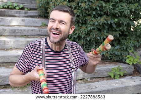 Cute male juggler practicing outdoors 