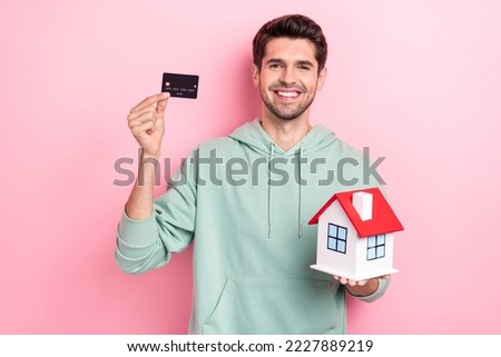 Photo of nice young man hands hold demonstrate small house debit card isolated on pink color background