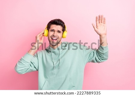 Photo of carefree crazy person arm touch headphones enjoy playlist isolated on pink color background