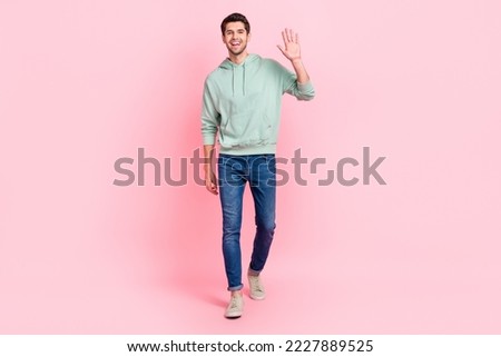 Full length photo of satisfied man dressed grey denim clothes raise arm say hi rejoice meet close friend isolated on pink color background Royalty-Free Stock Photo #2227889525