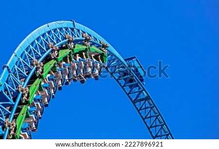 extreme rollercoaster arc on blue sky background. attractions Royalty-Free Stock Photo #2227896921