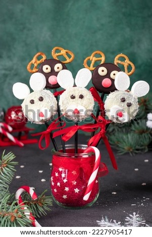 Christmas treats - cake pops Rabbits and Santa reindeers from cookies in chocolate, coconut flakes, marshmallows and crackers