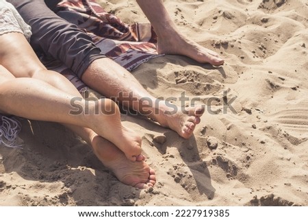 Close up human feet monochrome concept photo. People relaxing at beach. Side view photography with sandy coast on background. High quality picture for wallpaper, travel blog, magazine, article