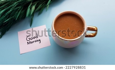 A glass of coffee, text good morning on a blue background.