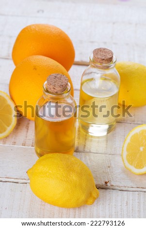 Essential aroma oil with citrus on wooden background. Selective focus.