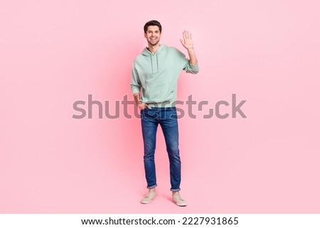 Full body portrait of satisfied young person arm palm waving hello hi isolated on pink color background Royalty-Free Stock Photo #2227931865