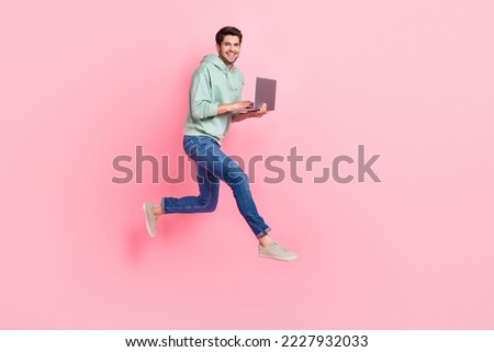 Full length photo of cheerful positive office worker wear stylish outfit go empty space device sale isolated on pink color background