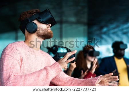 Young friends with simulation experience with futurist virtual reality glasses - Technology and metaverse concept Royalty-Free Stock Photo #2227937723