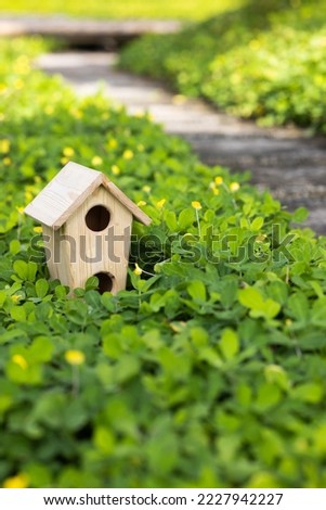 A birdhouse with the garden and the river.