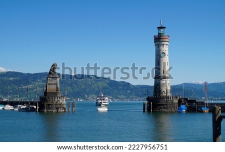 the beautiful harbour of Lindau island on lake Constance (Bodensee) with the Alps in the background, Germany on fine sunny spring day                                Royalty-Free Stock Photo #2227956751