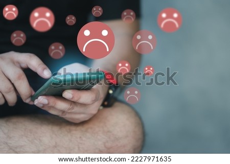 Unhappy and disappointed customers give low ratings and negative feedback in surveys online by mobile phone. Sad and dissatisfied man giving review about service quality. Bad user experience. Royalty-Free Stock Photo #2227971635