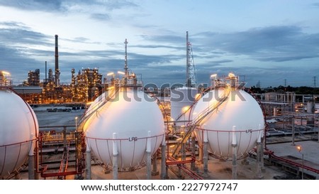 Gas storage sphere tank in petrochemical industry zone with oil and gas refinery factory plant petrochemical industry and oil storage tank background, Oil refinery at twilight. Royalty-Free Stock Photo #2227972747