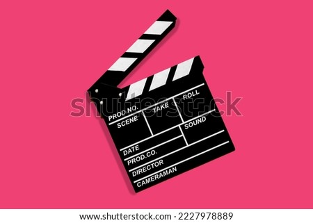 Clapperboard for shooting video footage takes on a pink background