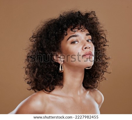 Black woman, beauty and skincare face portrait for natural afro, facial or hair care cosmetics. Healthy, beautiful and assertive model with curly hair shine and texture in brown studio background. Royalty-Free Stock Photo #2227982455