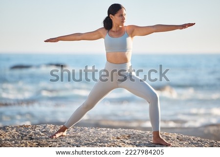 Yoga, stretching and beach woman with body wellness, fitness and pilates workout for outdoor healing, peace and goals.   health, healthy lifestyle and exercise girl in sports clothes by the sea Royalty-Free Stock Photo #2227984205