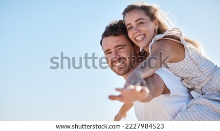Love, blue sky and happy couple together for summer, holiday and outdoor wellness, date anniversary and freedom with mockup. Happy woman and man piggyback ride for support, care and healthy lifestyle