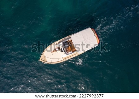 Drone top view of a little luxury boat sailing on the Mediterranean Sea Royalty-Free Stock Photo #2227992377