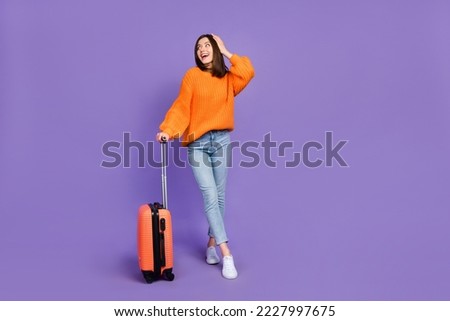 Full length photo of nice young lady touch head impressed traveler dressed stylish orange knitted look isolated on purple color background