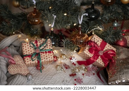 Beautifully wrapped gift boxes under the Christmas tree, close-up, winter holidays concept.