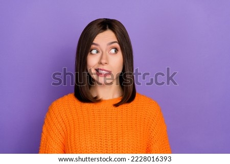 Portrait of minded clueless person grin teeth look empty space contemplate isolated on purple color background Royalty-Free Stock Photo #2228016393