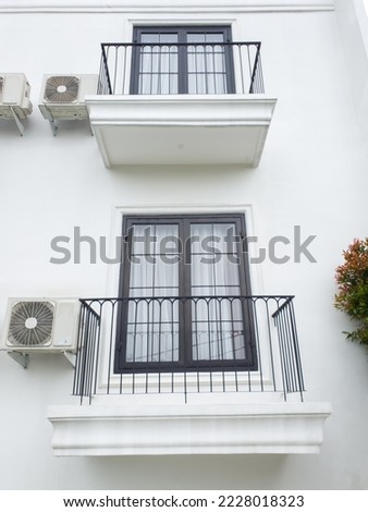 Two balcony up and down position. Glass window on the white wall.