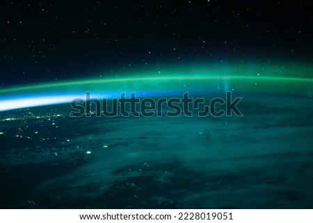Northern lights top of the world. Aurora blurry background. Colorful abstract light shapes backdrop. Elements of this image furnished by NASA Royalty-Free Stock Photo #2228019051