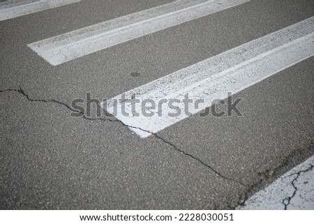 
abstract lines pedestrian crossing background road markings white stripes on the asphalt road, parking spaces separated by white lines, symmetrical abstract lines on gray asphalt	
 