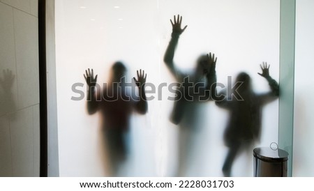 shadows of human figures, backlit children's bodies with open hands and raised arms Royalty-Free Stock Photo #2228031703