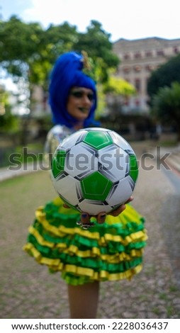 Supporter with a soccer ball and a flag