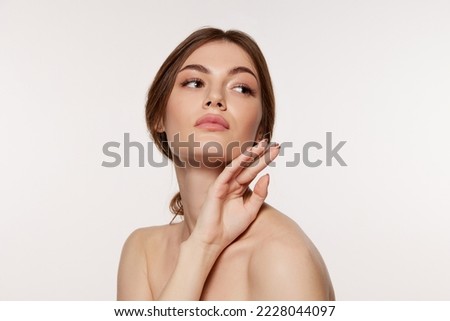 Portrait of young beautiful woman with perfect smooth skin isolated over white background. Concept of natural beauty, plastic surgery, cosmetology, cosmetics, skin care. Copy space for ad Royalty-Free Stock Photo #2228044097