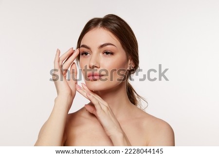 Portrait of young beautiful woman with perfect smooth skin isolated over white background. Taking care after skin with natural cosmetics. Concept of natural beauty, plastic surgery, cosmetology, care Royalty-Free Stock Photo #2228044145