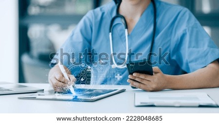 Medicine doctor working with smartphone and medical interface icons on the hospital background, Medical technology and healthcare concept.