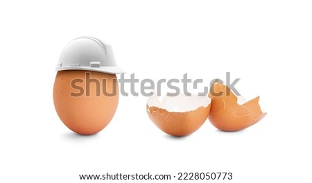 Conceptual representation of safety at work, Egg with a construction helmet and broken egg Royalty-Free Stock Photo #2228050773
