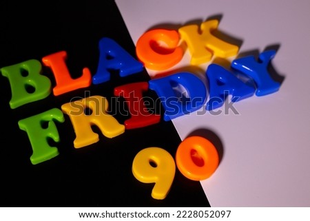 Plastic letters are placed on a black and white background and the word Black Friday and 90 Discounts are written.