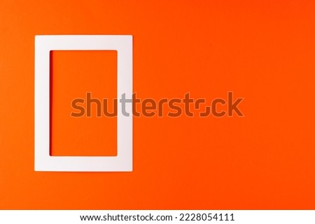 White frame on red bright background, the concept of minimalism.